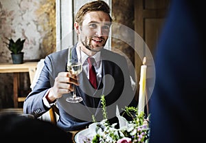Bride and Groom Clinging Wineglasses with Friends on Wedding Rec