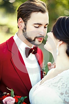 The bride and groom closeup, before kiss, outdoor, tenderness, passion. Wedding style Marsala, vertical portrait.