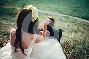 Bride and groom with corolla in a forest