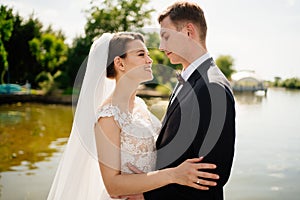 bride and groom dance by the water. beautiful and happy wedding in open air.