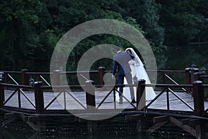 Bride and groom dancing on the bridge