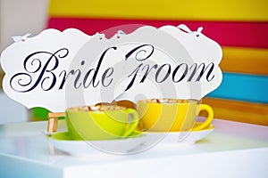 Bride and groom decoration boards and coffee cups