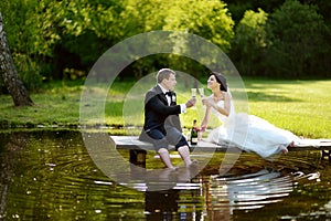 Bride and groom drinking champagne