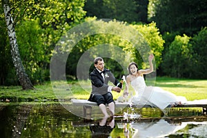 Bride and groom drinking champagne