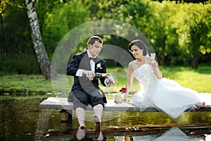 Bride and groom drinking champagne