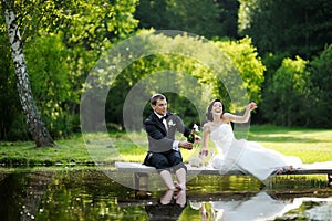 Bride and groom drinking champagne