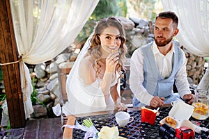 The bride and groom eat fast food. snack for the newlyweds