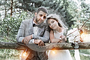 The bride and groom embrace in the forest on the wedding day. wedding ceremony. selective focus.