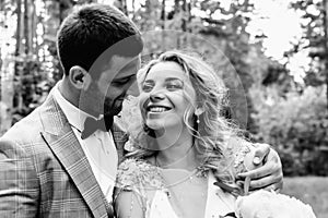 The bride and groom embrace in the forest on the wedding day. wedding ceremony. selective focus. film grain