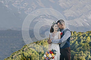 A bride and groom enjoy a view of mount hood in the background from this high elevation winery vineyard