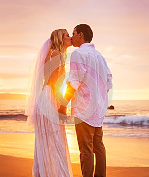 Bride and Groom, Enjoying Amazing Sunset on a Beautiful Tropical