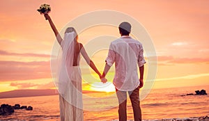 Bride and Groom, Enjoying Amazing Sunset on a Beautiful Tropical