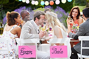 Bride And Groom Enjoying Meal At Wedding Reception