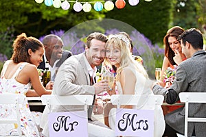 Bride And Groom Enjoying Meal At Wedding Reception