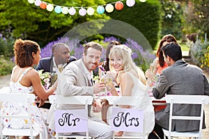 Bride And Groom Enjoying Meal At Wedding Reception