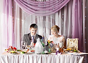 Bride And Groom Enjoying Meal At Wedding Reception