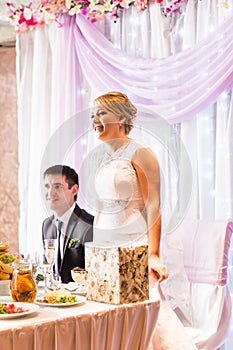 Bride And Groom Enjoying Meal At Wedding Reception