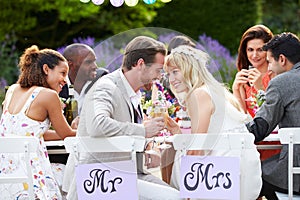 Bride And Groom Enjoying Meal At Wedding Reception