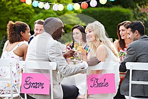 Bride And Groom Enjoying Meal At Wedding Reception