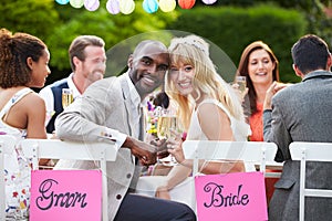 Bride And Groom Enjoying Meal At Wedding Reception