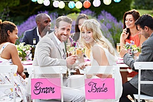 Bride And Groom Enjoying Meal At Wedding Reception