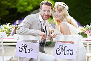 Bride And Groom Enjoying Meal At Wedding Reception