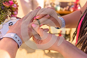 Bride and groom exchange rings during the wedding ceremony
