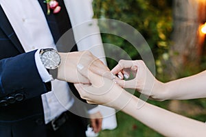 The bride and groom exchange rings during a wedding ceremony.Bride puts on silver ring bridegroom. a wedding in the
