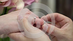 Bride and groom exchange wedding rings at ceremony. Lovely couple