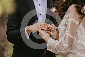 Bride and groom exchanging wedding rings during the ceremony.