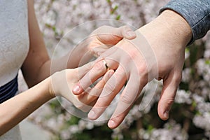 Bride and groom exchanging wedding rings