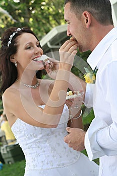 Bride and groom feeding cake upclose