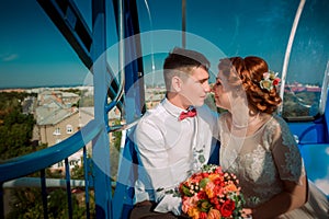 Bride and groom in the Ferris wheel