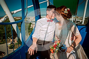 Bride and groom in the Ferris wheel