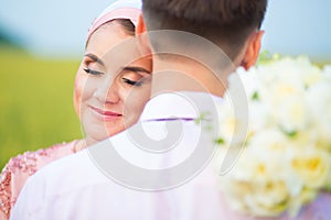 Bride and groom in field. Muslim marriage.