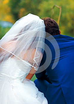 Bride and groom fishing together - romantic wedding concept.