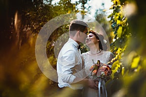 The bride and groom in the foliage of trees