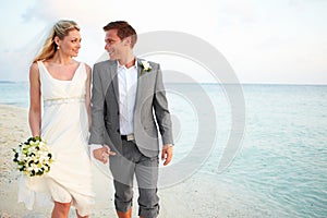 Bride And Groom Getting Married In Beach Ceremony