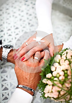 Bride and groom hand in hand together