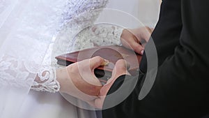 Bride and groom hands on bible. Bride and groom place their hands on the bible to exchange vows.