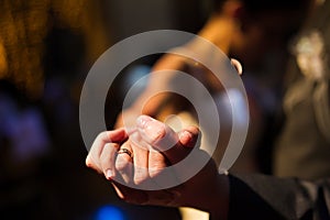 Bride and groom hands during the first dance