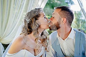 The bride and groom have fun and eat french fries. snack for newlyweds.