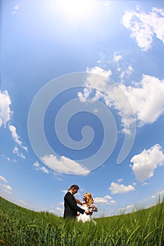 Bride and groom having fun on the fields