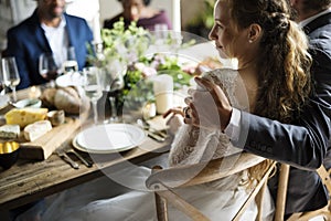 Bride and Groom Having Meal with Friends at Wedding Reception