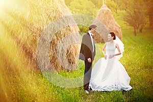 Bride and groom in the hay field