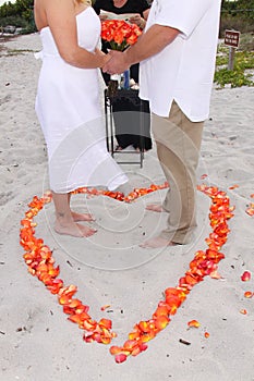 Bride and Groom in heart on sand