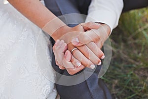 The bride and groom hold each other& x27;s hands