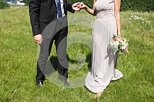 Bride and groom hold the hand