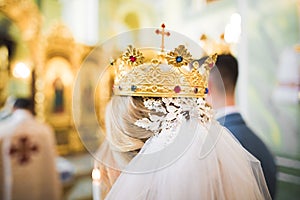 Bride and groom holding candles in church