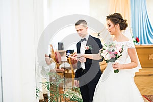 Bride and groom holding candles in church